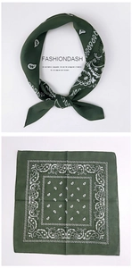 Detail of dark green cotton paisley scarf with vintage geometric border and soft texture