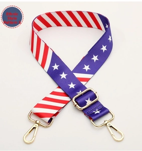 Close-up of adjustable wide strap with American flag pattern and gold metal hardware