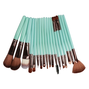 Macro detail of 18pcs mint green and rose gold makeup brushes with synthetic bristles