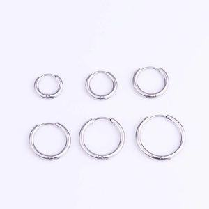 Set of six silver stainless steel hoop earrings in various sizes on a clean background