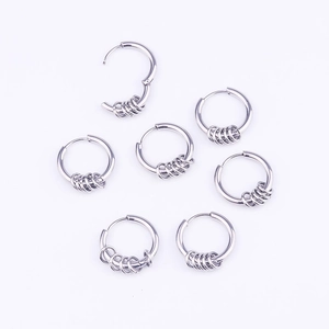 Set of seven silver stainless steel hoop earrings with small decorative rings