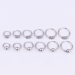 Set of 12 silver stainless steel hoop earrings in various sizes with beads and coils