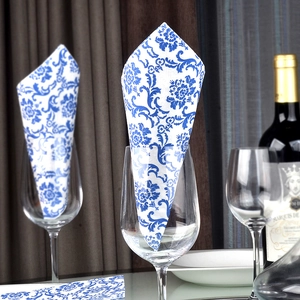 Blue floral paper napkins in wine glass on elegant dining table with classic Chinese style