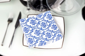 Blue and white floral patterns on square paper napkins for elegant wedding table settings