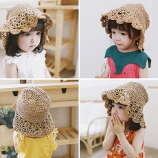 Detail of hollow woven straw kids sun hat in khaki showing breathable knitting pattern