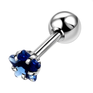 Macro shot of a blue star-shaped zircon stud earring with polished silver ball backing