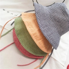 Flat lay view of checkered bucket hats in four colors with adjustable drawstrings