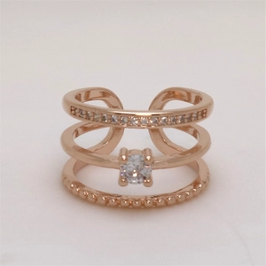 Detailed view of rose gold triple-layer ring with sparkling zircon stones and beaded band