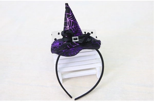 Detail of purple glitter spider web on a mini witch hat headband for Halloween party
