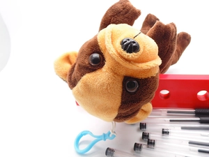 Detail of plush pug dog pencil case with blue clip and soft textured synthetic fur