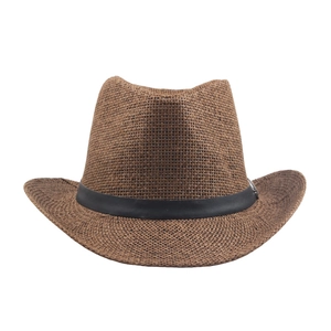 Brown straw jazz hat with wide brim and black band on a clean white background
