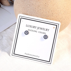 Sparkling Evil Eye stud earrings with blue crystals and silver-tone finish on luxury card