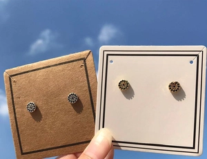 Detail of evil eye stud earrings featuring blue cubic zirconia on jewelry card
