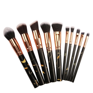 Detail of 10-piece makeup brush set with black marble handles and rose gold ferrules