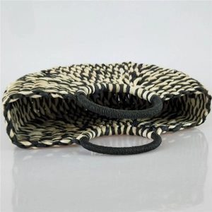 Handcrafted semicircular straw handbag with black and natural weave and round handles