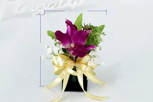 Detail of artificial purple orchid boutonniere with dimensions 14cm by 10cm