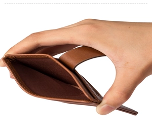 Detail view of brown leather card holder with fine stitching and slim slot design