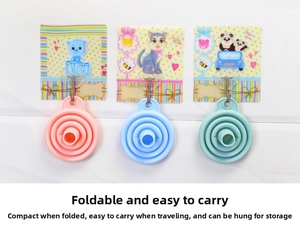 Three colorful collapsible silicone funnels hanging on a wall for easy kitchen storage