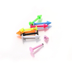 Colorful stainless steel labret studs with cone spikes and threaded ends set on white