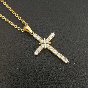 Close-up of gold-plated stainless steel cross pendant with inlaid AAA zirconias