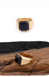 Macro shot of men's square gold stainless steel ring with flat black onyx stone inlay