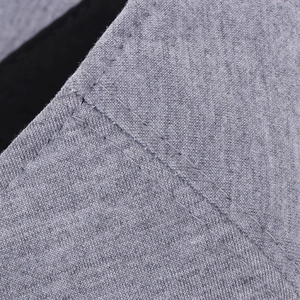 Macro detail of grey cotton beret showing fabric texture and neat double-stitched seams