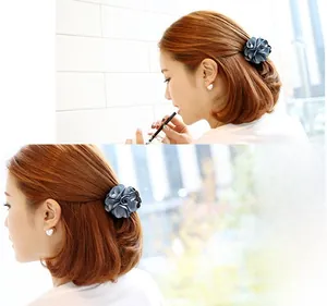 Detailed close-up showing the blue fabric rose hair clip texture on a female model