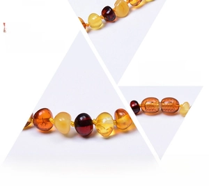 Detail of amber necklace featuring safety breakaway clasp and individual knotting craft