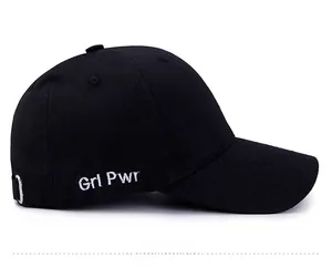 Close-up of black baseball cap with white side embroidery Grl Pwr lettering