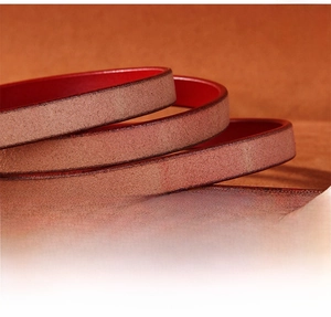 Close-up of finely polished leather belt edges with contrast color stitching detail