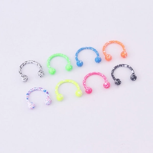 Eight colorful horseshoe septums with splatter patterns in stainless steel for body piercing