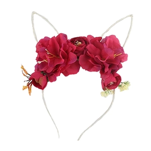 Detail of red faux silk flower cat ear headband for parties and vacations