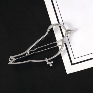 Minimalist silver bird shaped cutout metal hair clip with a modern hollow silhouette