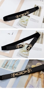 Detail of black elastic belt featuring vintage gold alloy hook clasp and premium texture