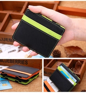 Detail of magic wallet with textured black synthetic leather and neon green card slots