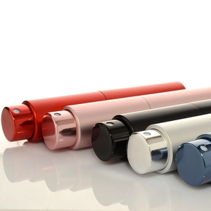 Five colorful 10ml refillable travel perfume atomizers in a row on a white surface
