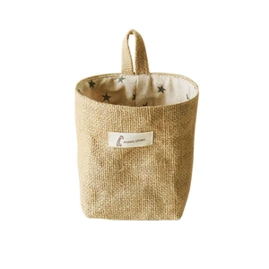 Hanging jute storage basket with star pattern lining and handle for wall organization