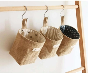 Detail of hanging jute storage bags with star, stripe, and polka dot cotton linings