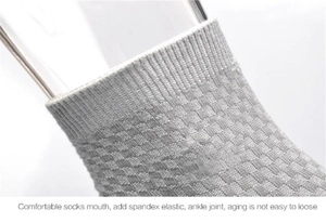 Close-up of gray bamboo fiber sock cuff with elastic ribbing and diamond mesh texture