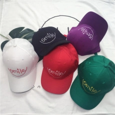 Flat lay of colorful PU leather baseball caps featuring Smile embroidery and curved lines