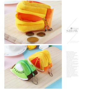 Detail of plush fruit coin purse showing interior capacity for coins and metallic bead chain