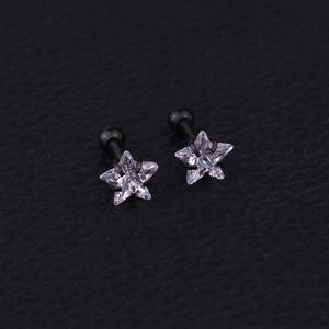 Macro view of black stainless steel star ear studs with sparkling cubic zirconia crystals