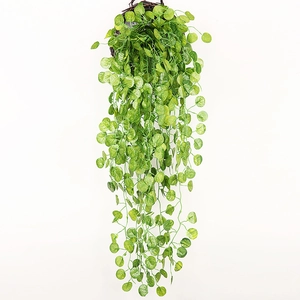 Close-up of realistic artificial hanging green ivy in a woven basket for home decor