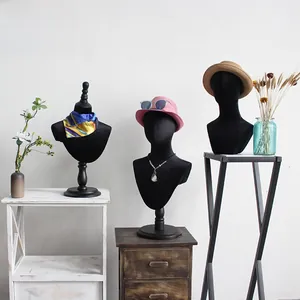 Three assorted black velvet mannequin heads for displaying hats and accessories