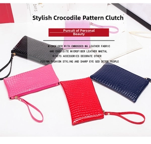 Detailed display of crocodile pattern clutch bags in various colors with wrist straps