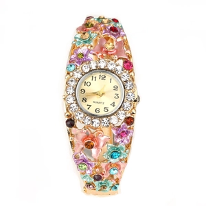 Detailed close-up of golden floral bracelet watch with enamel flowers and colorful crystals