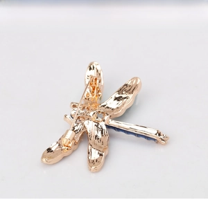Detail of the dragonfly brooch with a gold-plated alloy back and secure pin clasp mechanism
