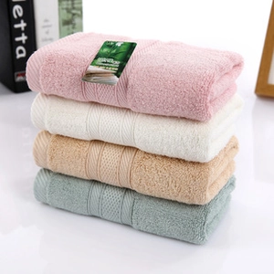 Close-up of stacked colorful microfiber cleansing towels in pink, white and green colors