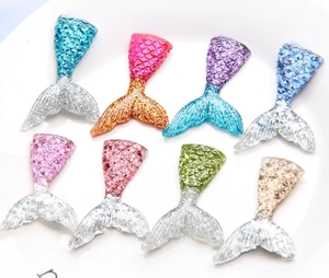 Macro shot of colorful resin mermaid tails with glitter texture for DIY craft decoration