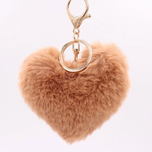 Close-up of heart-shaped camel faux fur keychain with gold-tone metal clasp and ring